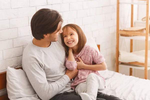 Bonita menina brincando com seu jovem pai em casa — Fotografia de Stock