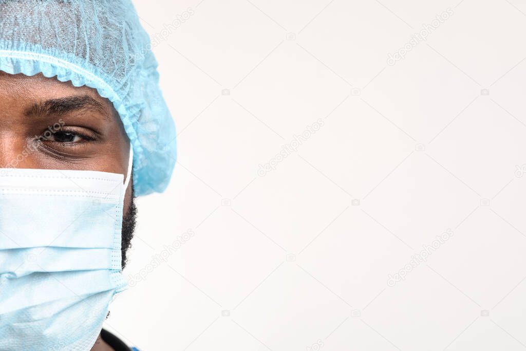 Half face portrait of african doctor with face mask