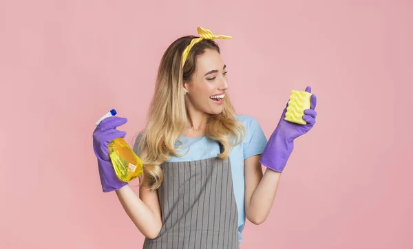 Household chores with fun. Housewife holds spray