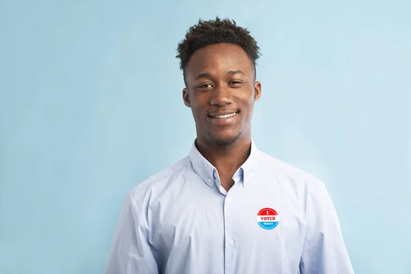 Happy african patriotic citizen pinned vote button on t-shirt — Stock Photo, Image