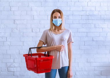 Coronavirus konsepti sırasında market alışverişi. Sepetli kız.