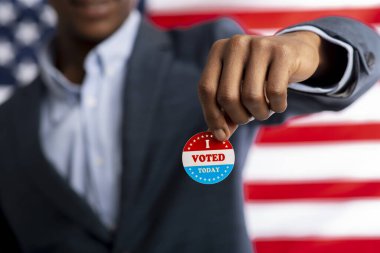 Unrecognizable african citizen of America holds I voted today clipart