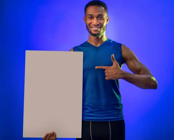 Fitness Guy Holding White Board For Text On Blue Background