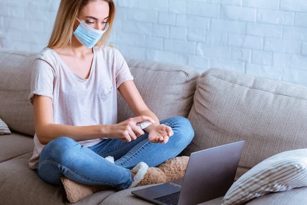 Hand disinfection protects against virus. Girl remote working — Stock Photo, Image