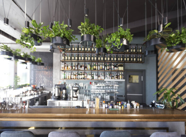Blurred empty bar counter interior in stylish cozy cafe