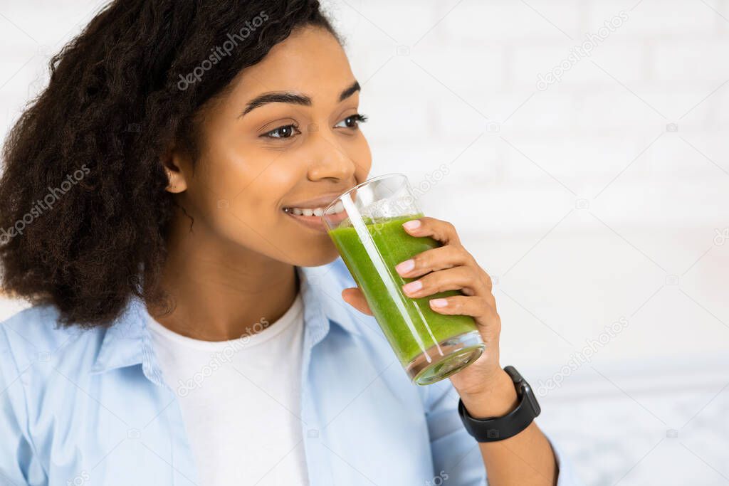 Afro Girl Drinking Smoothie And Looking Aside