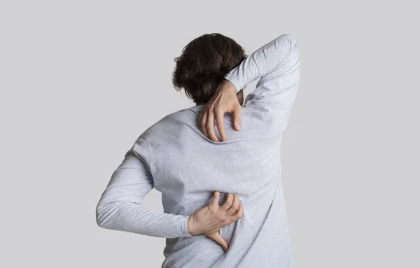 Dermatological problems concept. Man has itchy back — Stock Photo, Image