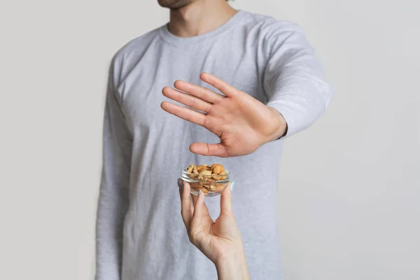 Allergy concept. Man refuses nuts, free space — Stock Photo, Image