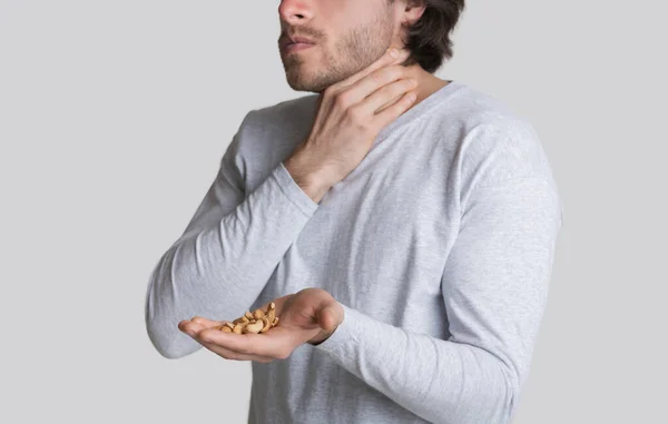 Allergic reaction to nuts, man suffocates, free space — Stock Photo, Image