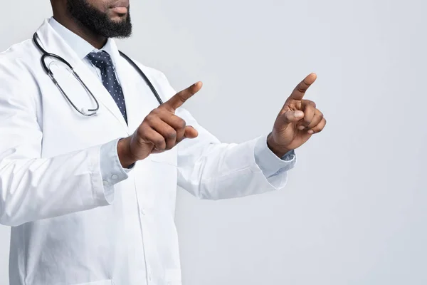 Cropped of black doctor pointing with two fingers