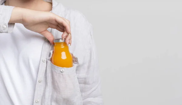 Woman getting out of pocket small glass bottle for refilling energy balance — Stock Photo, Image