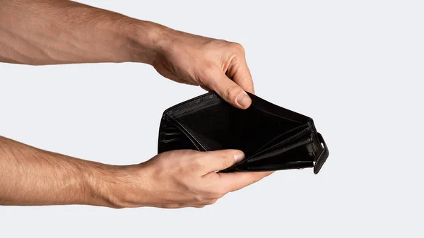 Coronacrisis and bankruptcy. Closeup of businessman holding empty wallet on white background, panorama — Stock Photo, Image