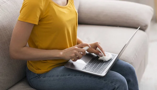コロナウイルスに対する衛生状態。家庭でノートパソコンのキーボードをきれいにするために防腐剤を使用して千年の女の子,クローズアップ.パノラマ — ストック写真