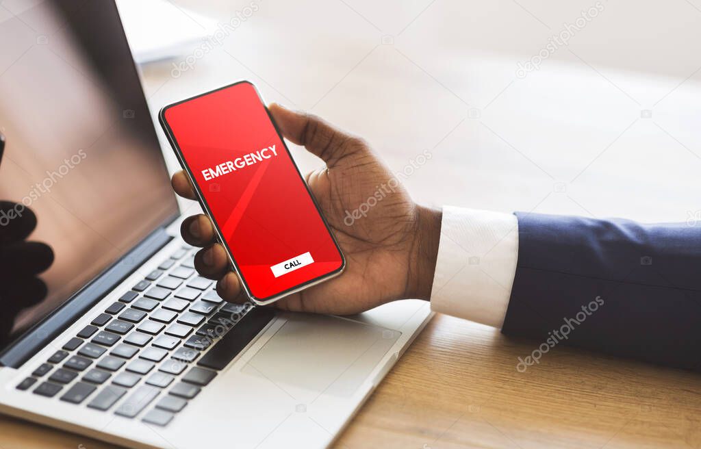 Worker holding smart phone with emergency number