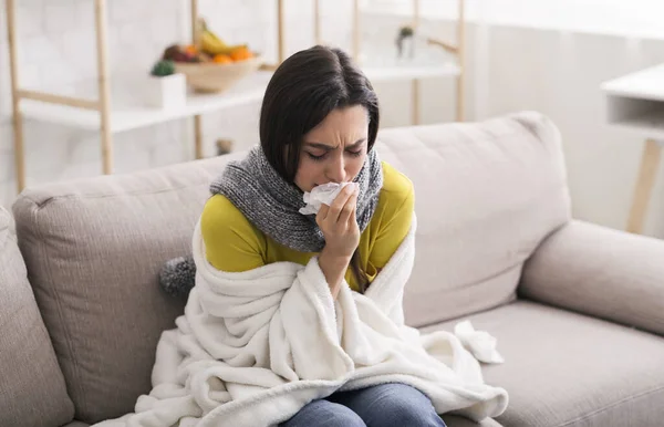 Infectious disease. Lovely girl wrapped in warm blanket suffering from virus at home — Stock Photo, Image