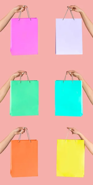 Female hands showing shopping bags of different colors on pink background, collage. Space or design — Stock Photo, Image