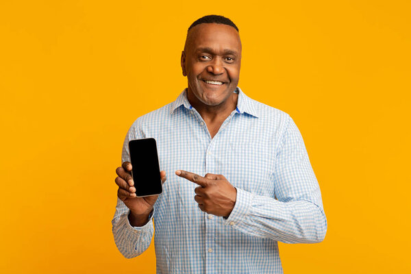 Middle aged black man showing blank cellphone screen