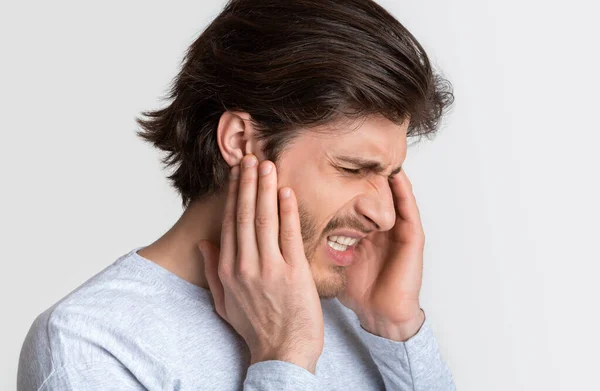 El hombre con dolor de oído tiene dolor de cabeza. — Foto de Stock