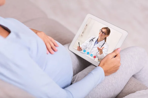 Woman having video chat with doctor on tablet at home — Stock Photo, Image