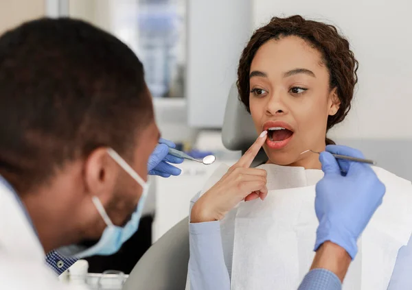 Paciente femenina en silla de dentista mostrando sus dientes — Foto de Stock