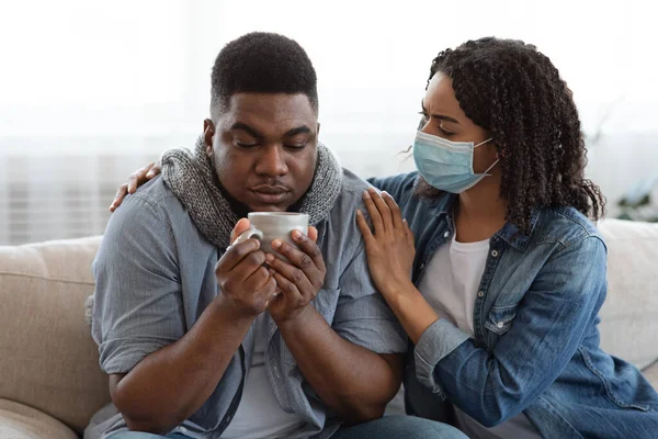 Caring Black Wife Looking After Her Ill Husband With Coronavirus At Home