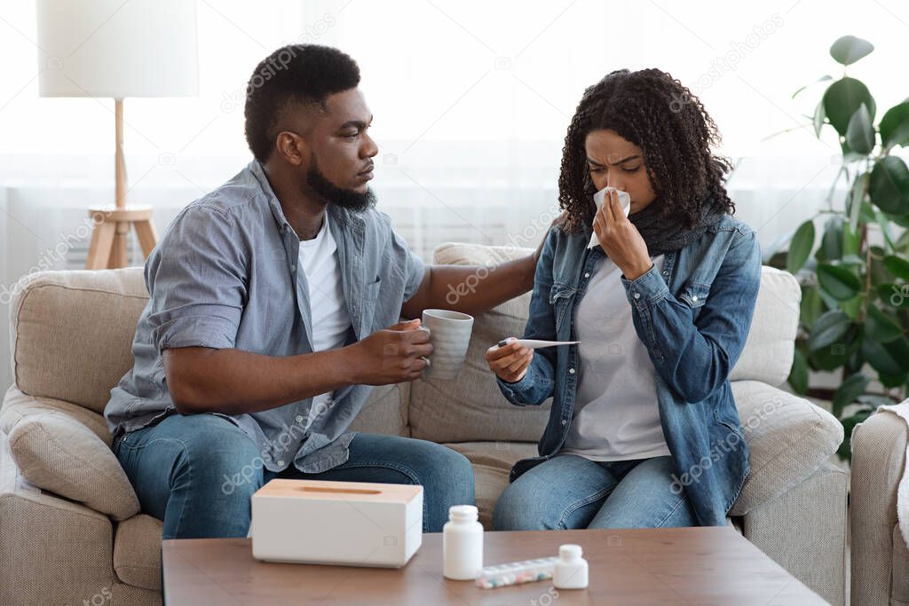 Caring Black Man Looking After His Ill Wife At Home