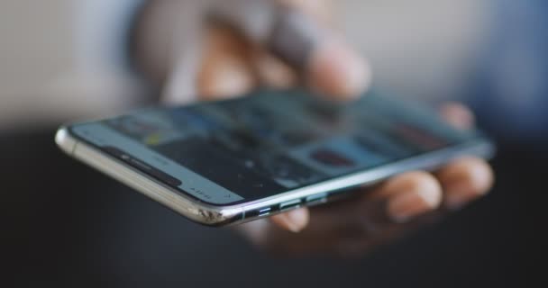 Africano chico desplazándose aplicación de redes sociales en el teléfono celular, de cerca — Vídeo de stock