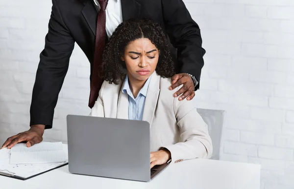 Acoso sexual en el cargo. Jefe afroamericano abusando de su empleada en el lugar de trabajo — Foto de Stock