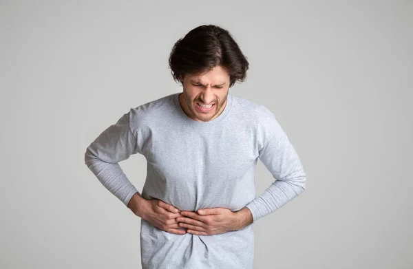 Face expresses torment acute pain in stomach — Stock Photo, Image