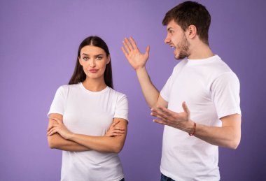 Young man arguing with his girlfriend who ignoring him clipart
