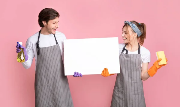 Blank White Advertisement Placard In Hands of Couple Holding Cleaning Tools — стоковое фото