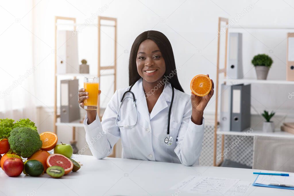 African woman dietician recommending fresh orange juice