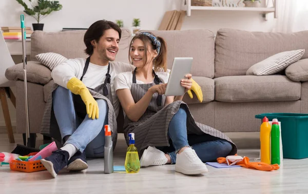 Cheerful Young Couple Relaxing With Digital Tablet After Cleaning Apartment — Stock Photo, Image