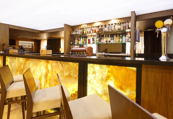 Futuristic hotel bar. Yellow-brown design with high chairs