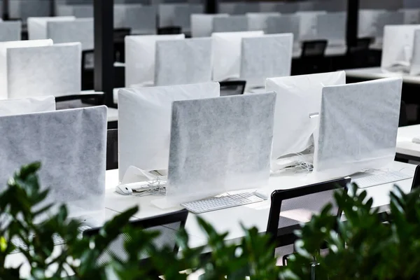 Big office with covered computers with no workers — Stock Photo, Image