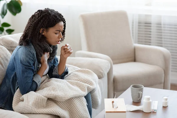Respiratory illness. Sick black woman coughing hard at home — Stock Photo, Image