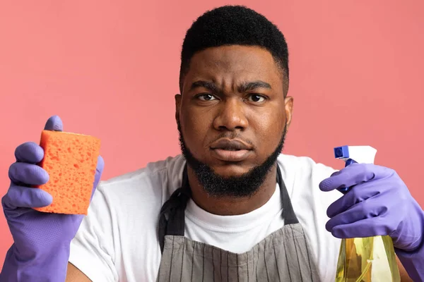 Accurate Black Couple Holding Cleaning Tools And Looking Suspiciosly At Camera