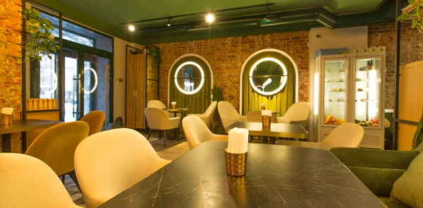 Light walls and green furniture in stylish restaurant design