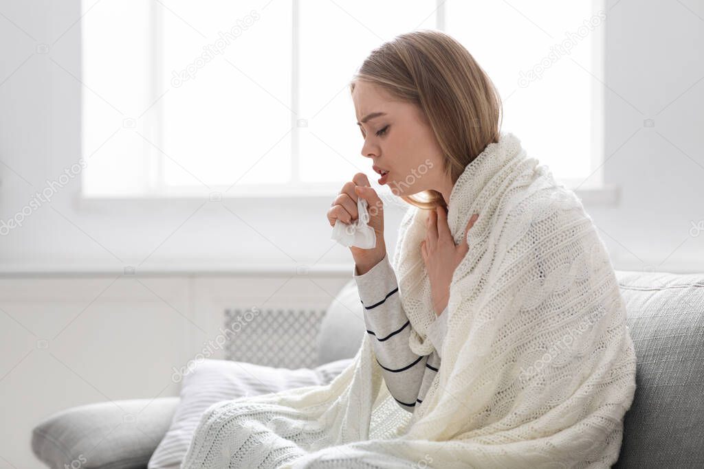 Sick young woman coughing at home, empty space