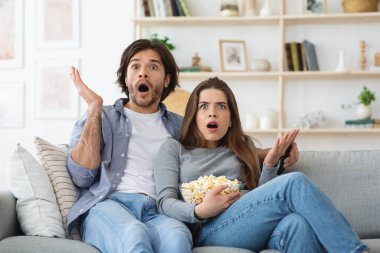 Korku seyreden ve patlamış mısır yiyen çiftler.