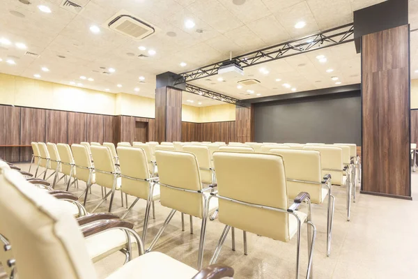 Audience for presentations. Large hall with wooden walls