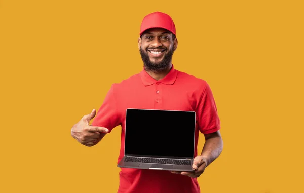 ( 영어 ) Courier Holding Laptop With Blank Screen On Yellow Background, Mockup — 스톡 사진