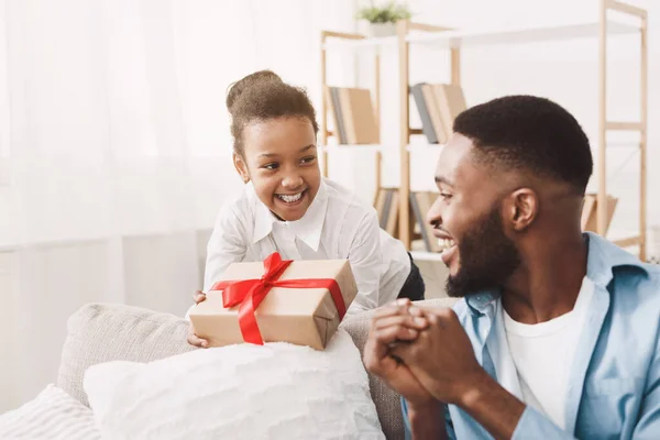 Birthday gift. Afro girl giving present to father — Stock Photo, Image