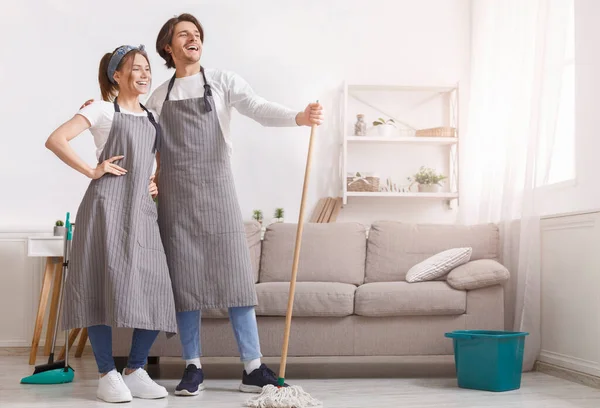 Cleaning Professionals. Couple Of Cleaners In Aprons Posing In Home Interior — Stock Photo, Image