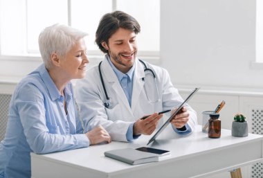 Doctor showing analysis results to senior patient clipart