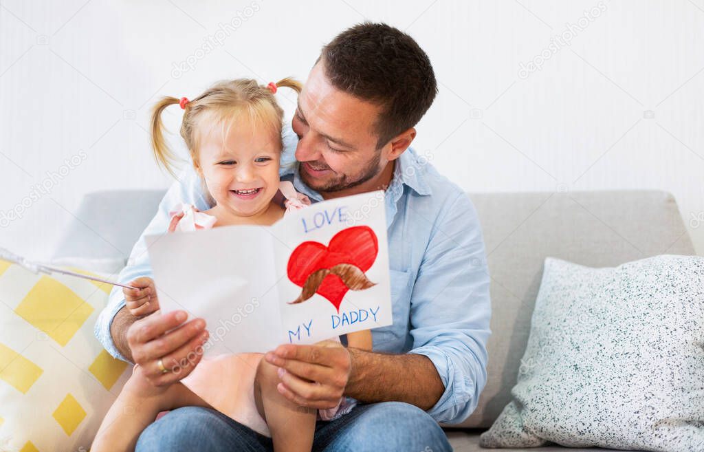 Little daughter congratulating dad with fathers day