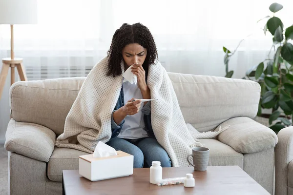 Flu Symptoms. Ill African Woman Checking Her Body Temperature At Home