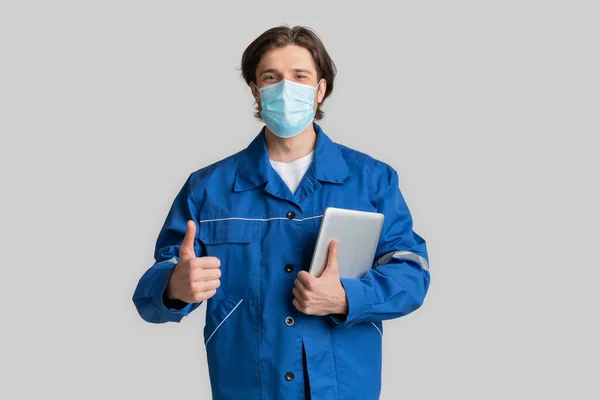 Coronavirus Protection At Work. Civil Ingineer In Medical Mask With Digital Tablet