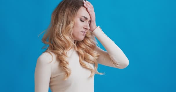 Sick girl with fever touching forehead and looking at thermometer — Stock Video