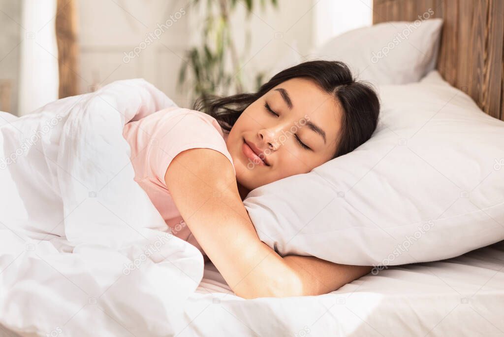 Asian Woman Sleeping Lying In Bed At Home Hugging Pillow